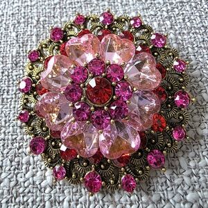 Vintage-style red and pink rhinestone floral brooch set in gold-tone metal.
